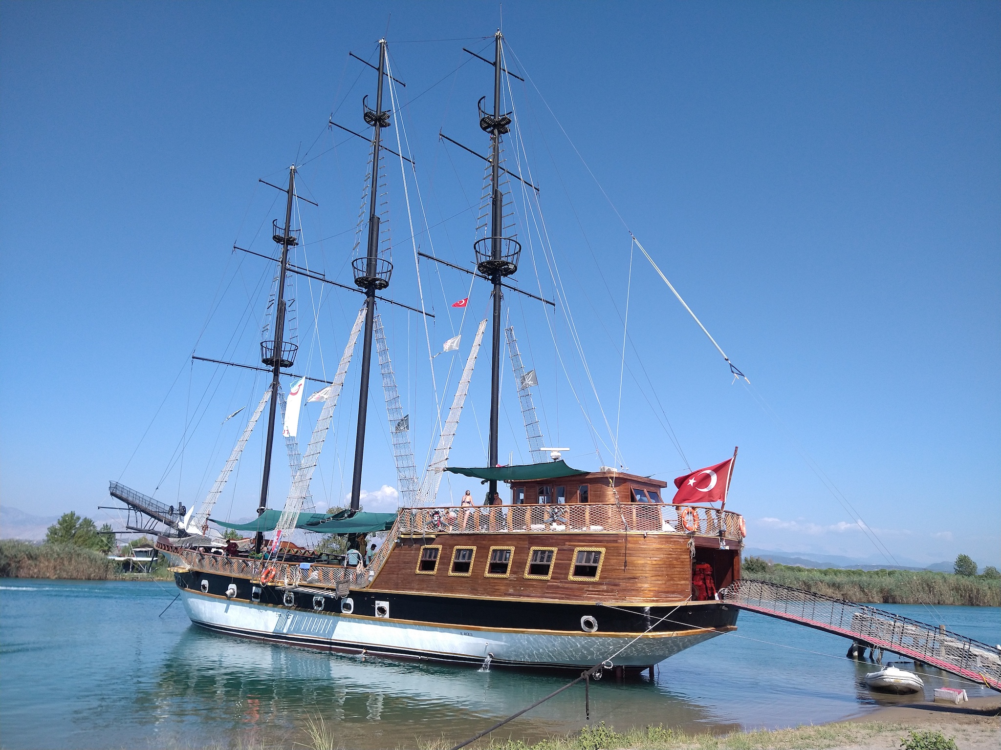 Pirate day cruise ship Barbaros moored on a sand bank.